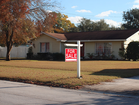 a home in ocala, fl with a for sale sign in the front yard.